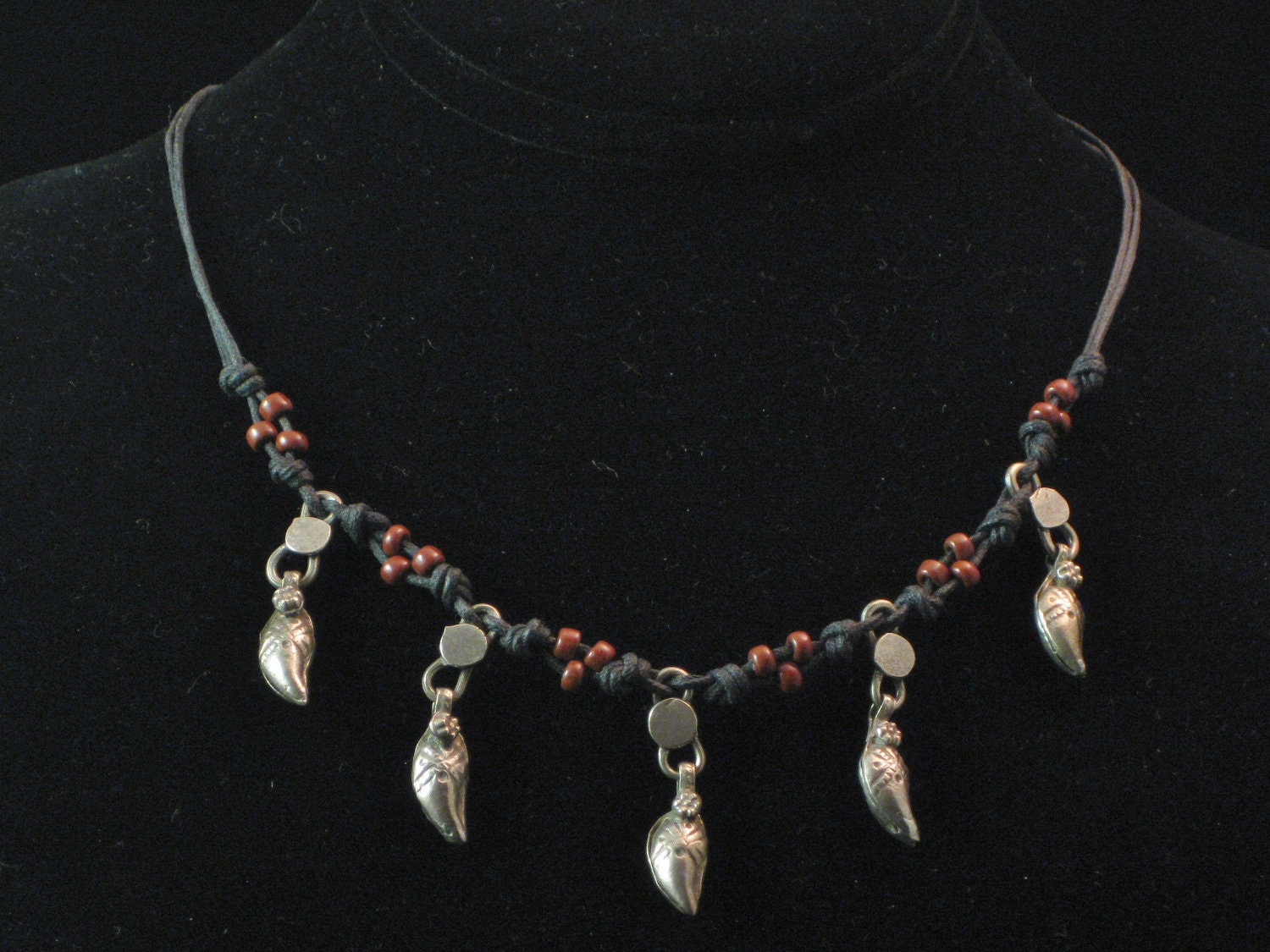 Necklace: Afghani feather amulets with African brown beads