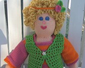 Molly, a hand knitted doll with two outfits