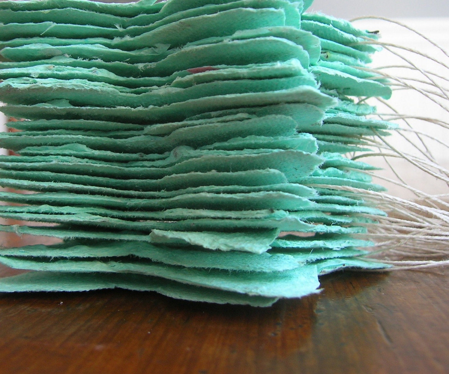 Sea foam green butterfly shaped favors made of plantable handmade paper embedded with perennial flower seeds