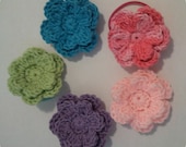 Crocheted girls pony o flower ponytail in pink purple lime green and blue