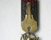 Upcycled repurposed domino and key necklace done in the Steampunk style
