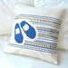 Natural white cotton pillow cover with design of little shoes in Mediterranean blue over mosaic design with envelope closure 18 x 18 inches