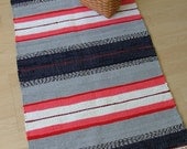 TRADITIONAL STRIPE -- Hand-woven pink, red, gray, white, and black rug