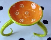 colorful orange ceramic bowl w/ long curly legs