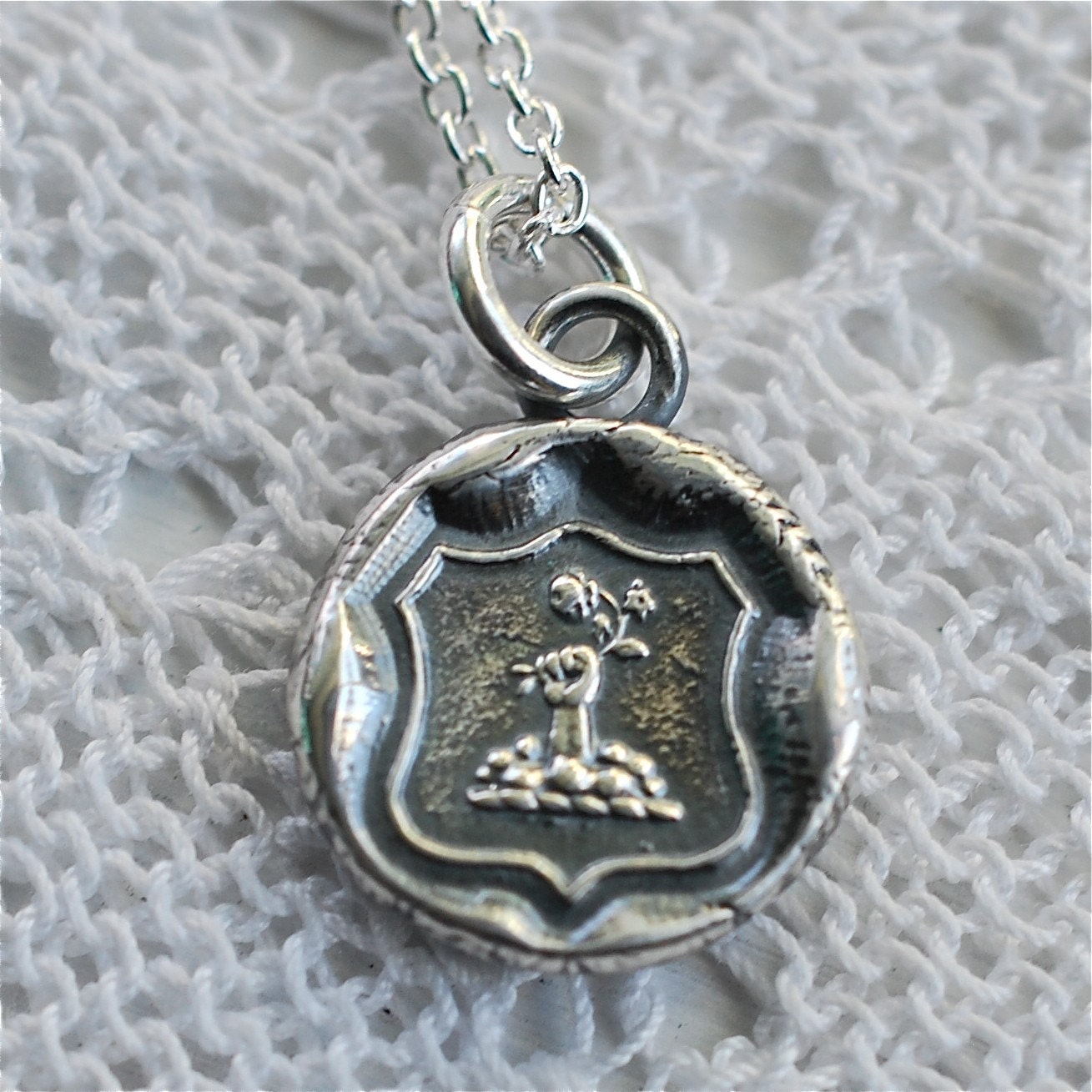 fist and flowers armorial wax seal pendant... hope and joy