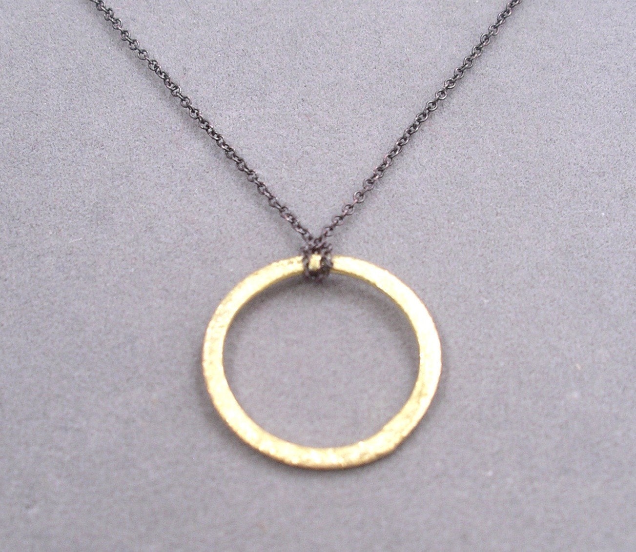 small gold ring on oxidized silver chain necklace