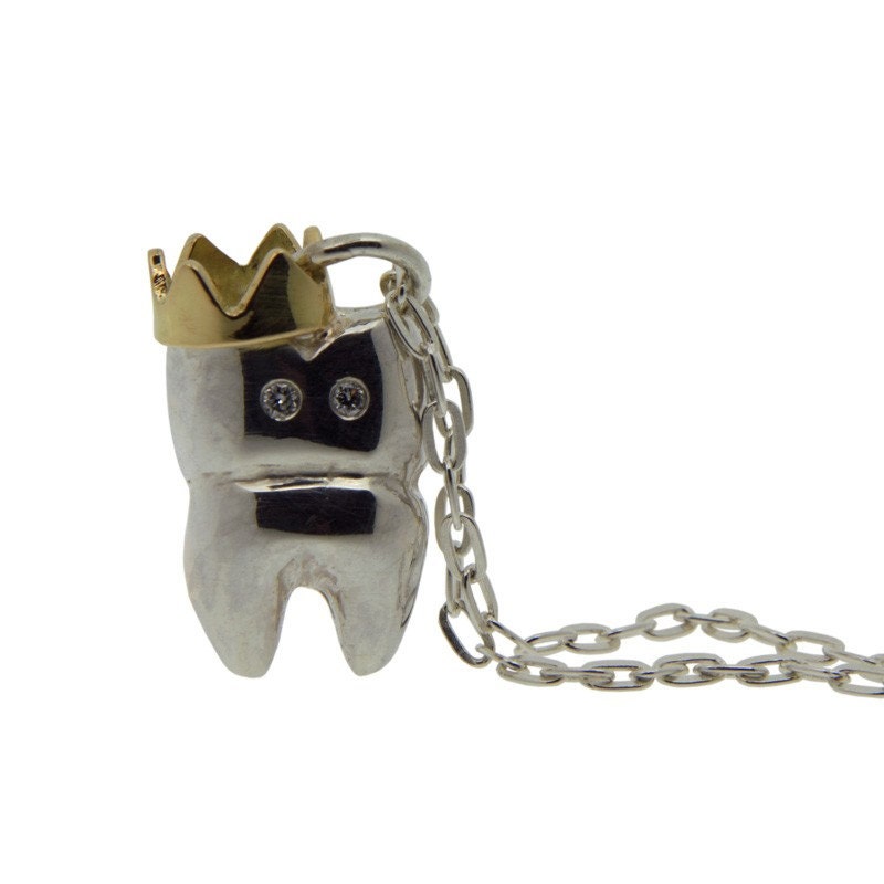 Jonathan Tooth Necklace. silver chain and pendant with 18ct gold crown and diamond eyes.