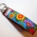 Keychain, key fob, key wristlet, key holder. Flowers. Blue, red, yellow, purple, orange, green.
