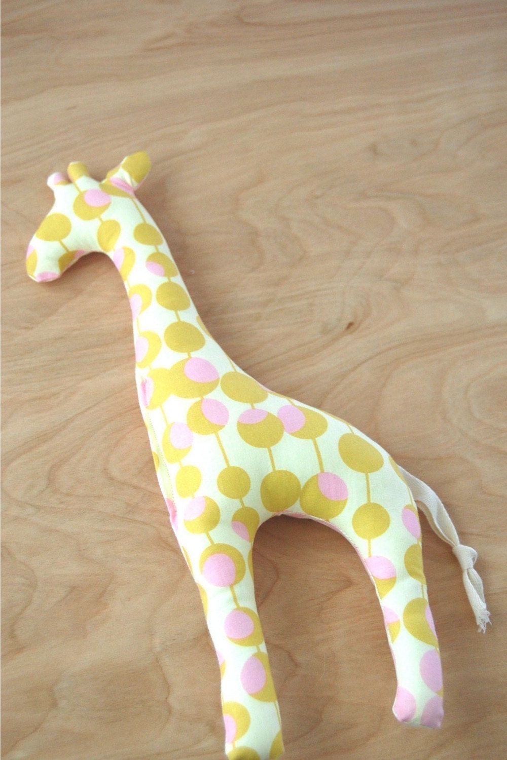 giraffe stuffed toy. pink and mustard