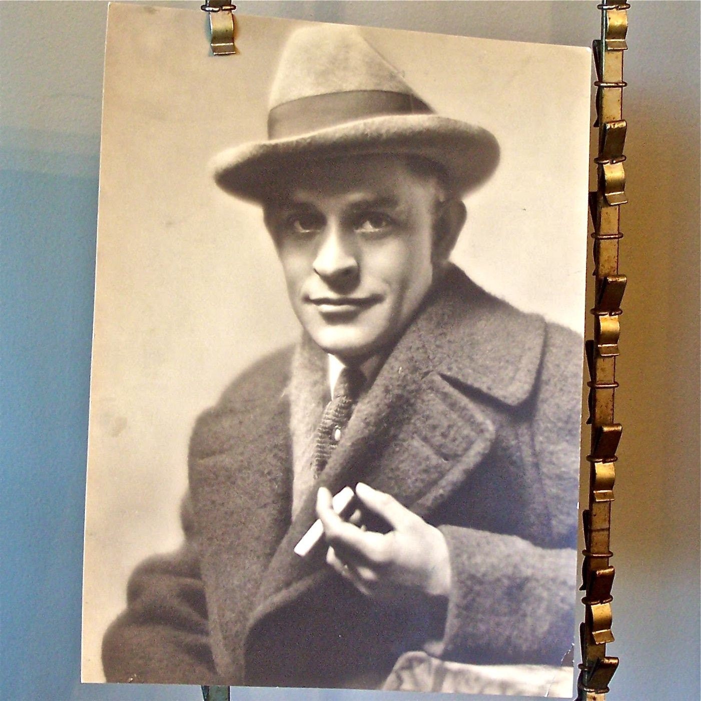 Vintage photo of man in fedora and overcoat smoking a cigarette - professional photograph