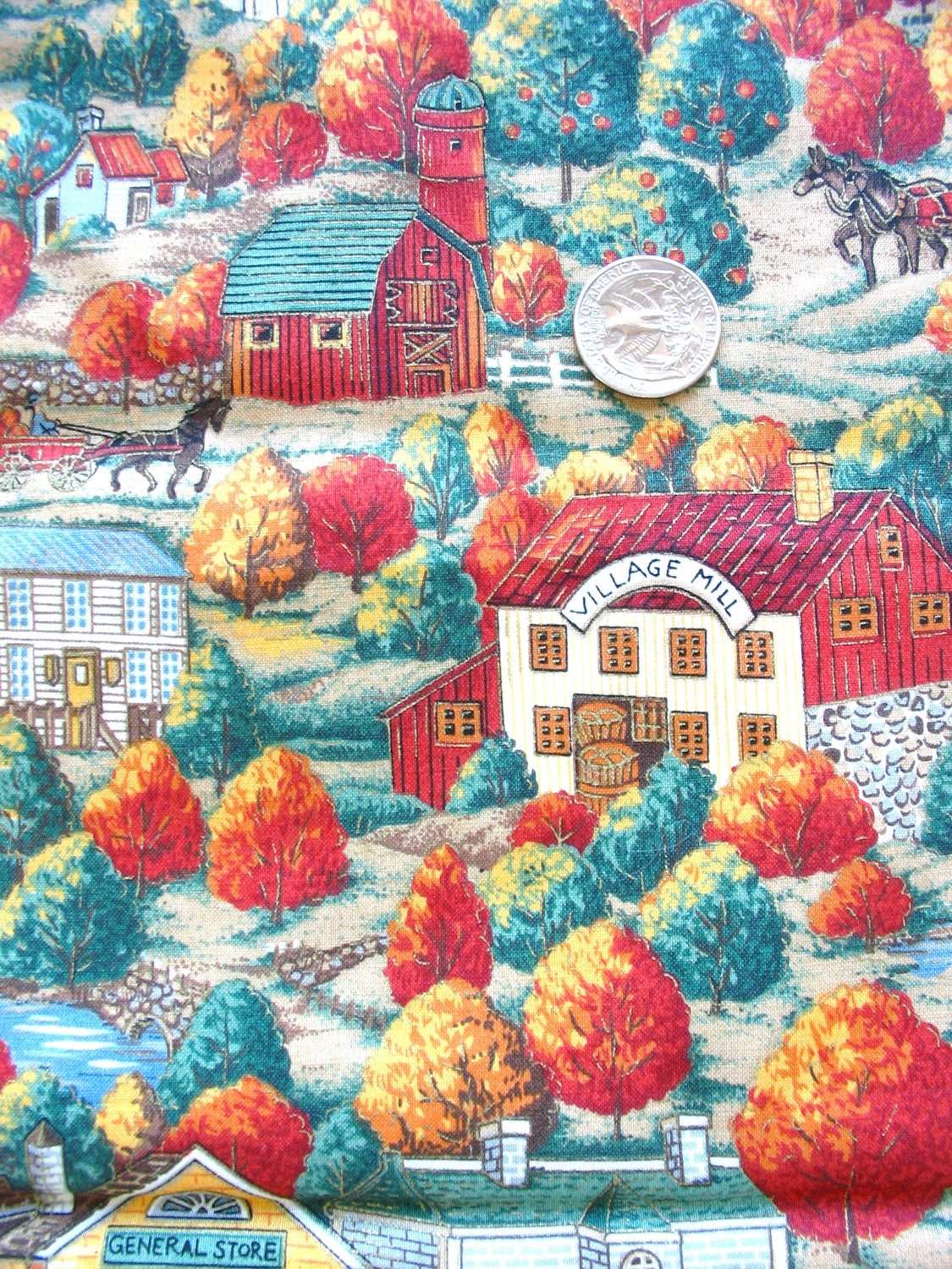novelty print cotton fabric of village scene in autumn by cranston works