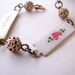 Shabby bracelet with vintage enamel roses and filigree