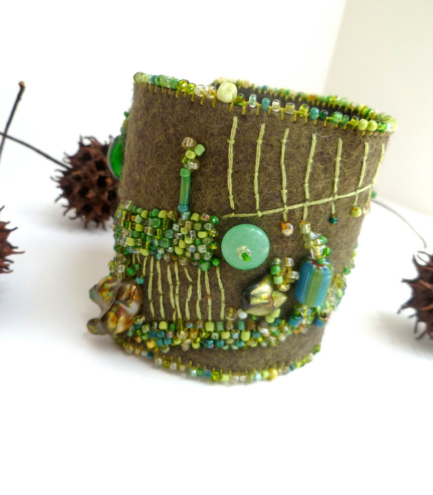 Fragments in green, fiber art cuff