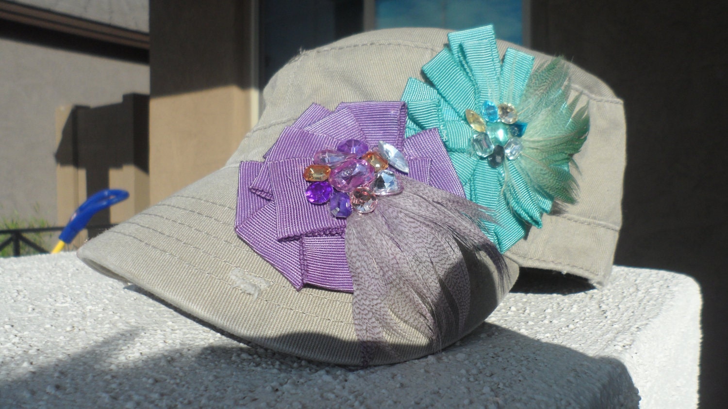 Fancy Feathers Tan Military Style Cadet Hat With Mint Blue and Purple Ribbon Flowers with embellished jeweled centers