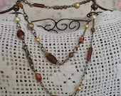 Ladies necklace..brown..pearls..brass chain..long