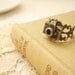 papparazi - a filigree camera ring.