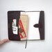 Handmade book with pockets. Bound in vintage leather wallet.