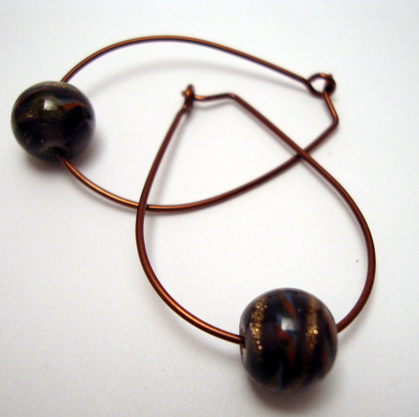 Pear shaped copper hoop earrings with plum purple art glass bead
