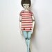 miniature moveable paper doll (in red stripes)