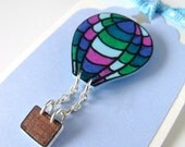 green, blue and purple hot air balloon brooch with dangly basket