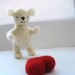 Woolly the shy Ted. Needlefelted white teddy bear with red heart.