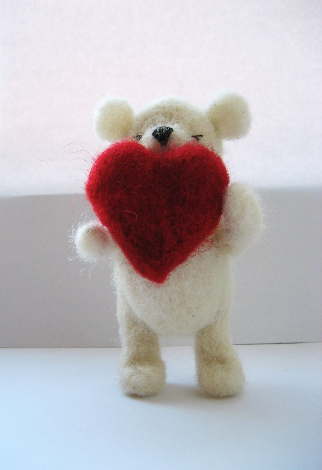 Woolly the shy Ted. Needlefelted white teddy bear with red heart.