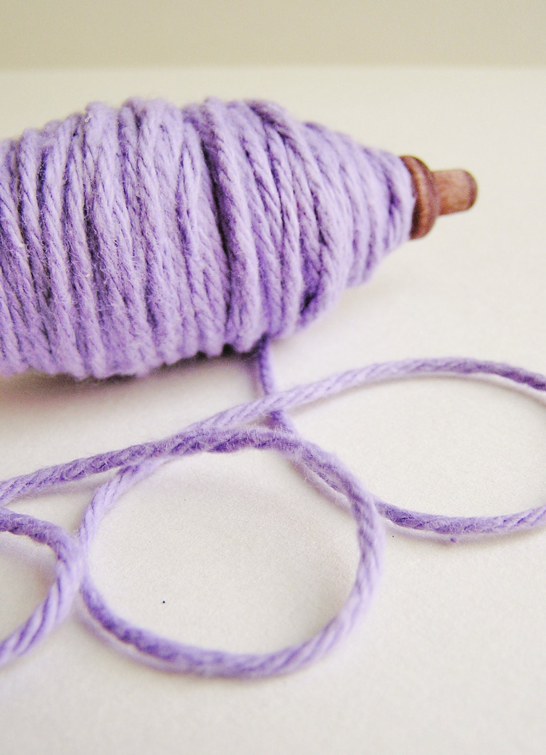Lavender thick cotton twine on a chocolate spindle