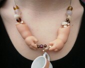 Scary Doll Arm Tea Party Necklace with Tea Cup and Faux Teeth Beads.