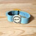 Baby Doll fake watch in BLUE AQUAMARINE. One-of-a-kind handmade Porcelain toy clock with recyclet leather watchband.