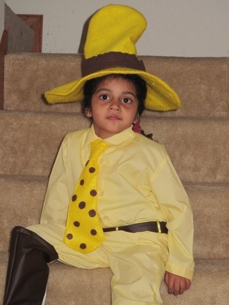man in yellow hat costume curious george