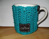 crocheted coffee mug cozy or java jacket in bright peacock blue with eco felt hand stitched coffee tag