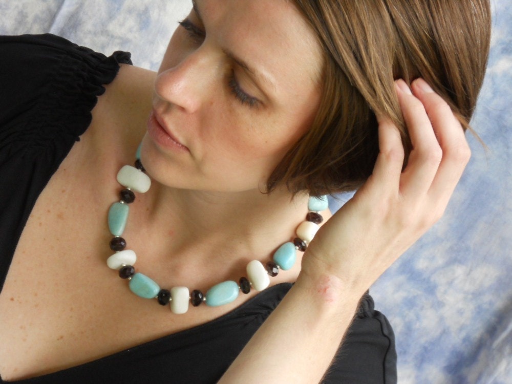She was an American Girl necklace - red glass, white calcite, robin's egg blue marble