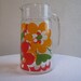 A vintage Juice Pitcher Orange and Red Flowers