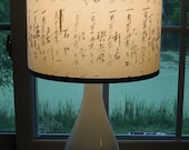 white glass lamp base with typographic paper lamp shade