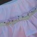 Newborn (Small) waterproof diaper cover wrap with leg gussets with a 2 layer ruffle and ribbon and a bow on the back