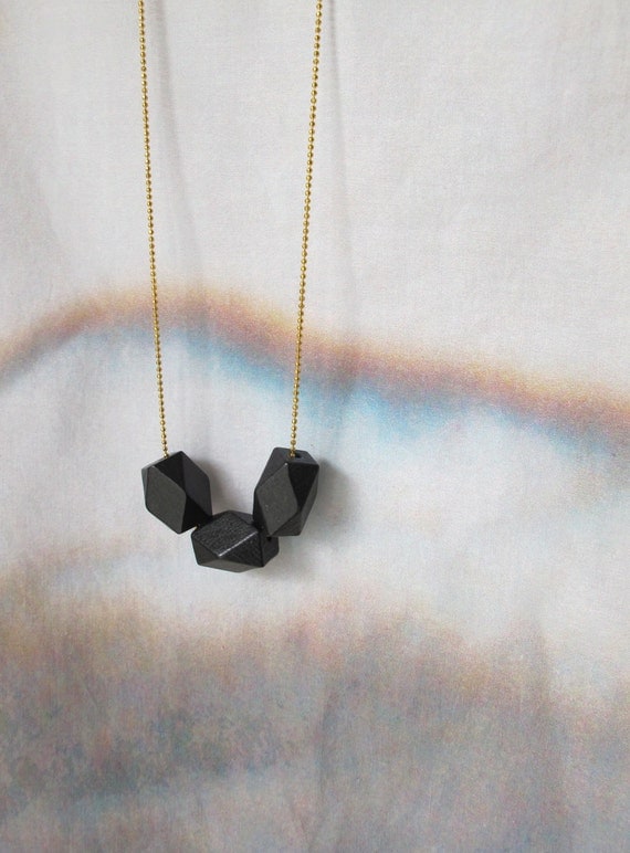 geometric necklace with faceted black wooden beads on a puristic fine ballchain