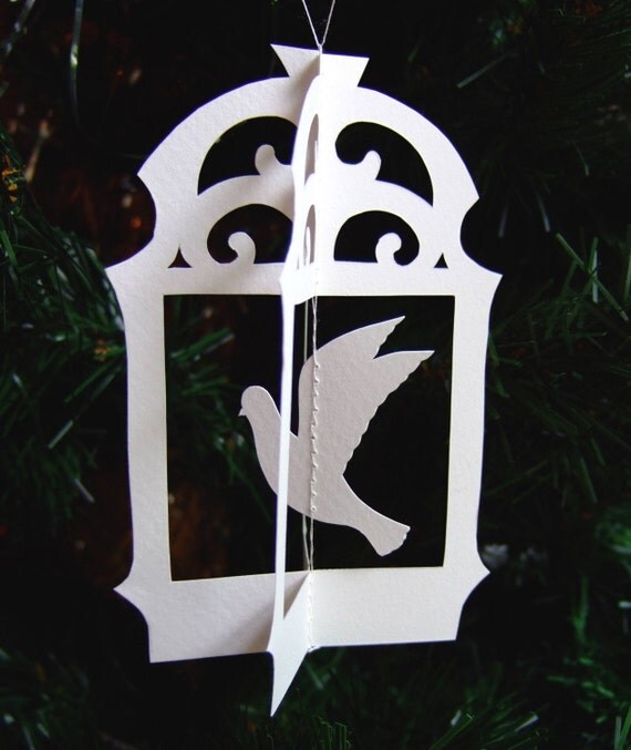Original hand cut papercut of flying bird in cage - ivory