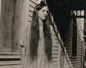 Girl with very long hair in front of wooden house - Antique vintage photo snapshot