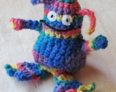 Amigurumi monster toy, crocheted in a bright pastel rainbow medley, 5.25 inch tall