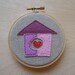 HOME embroidered wall art in carnation