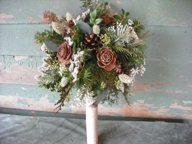 Bridal bouquet made with fresh evergreens and pine cones with birch handle. For your winter woodland natural wedding.