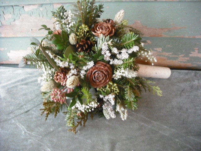 Bridal bouquet made with fresh evergreens and pine cones with birch handle. For your winter woodland natural wedding.