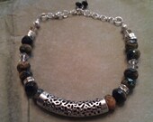 glass rondelle bracelet in indigo,tan and cream with silver tube bead and crystals.