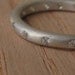 Moissanite and Silver Eternity Band