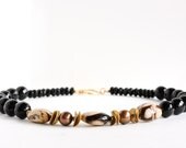 Handmade necklace of peanut wood jasper, onyx, and pearls