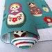 eco friendly baby quilt with matryoshka dolls on organic turquoise blue