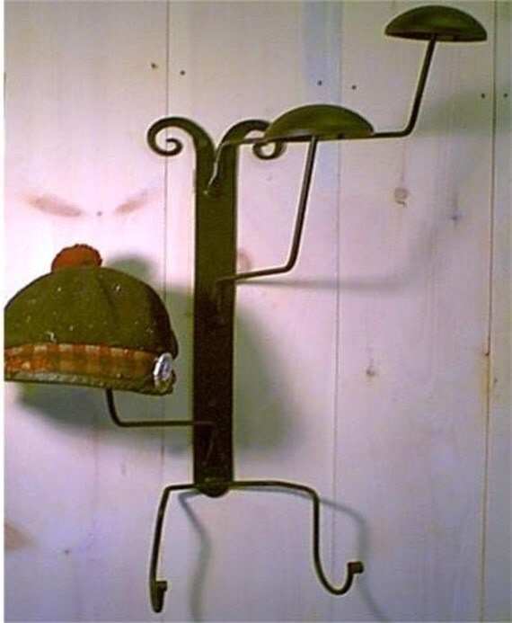 Hat rack hangs on the wall arms swivel and is by scottishlion