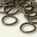 100....Jumpring, antiqued gold-plated brass, 10mm fancy round
