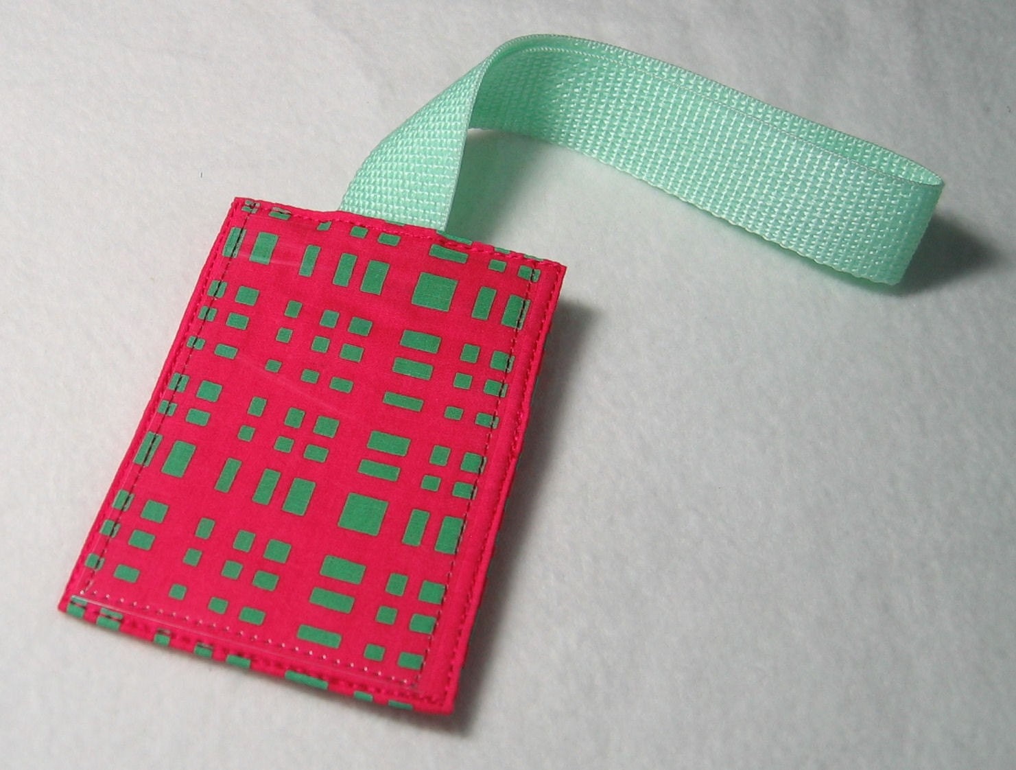 Neon pink and green luggage tag
