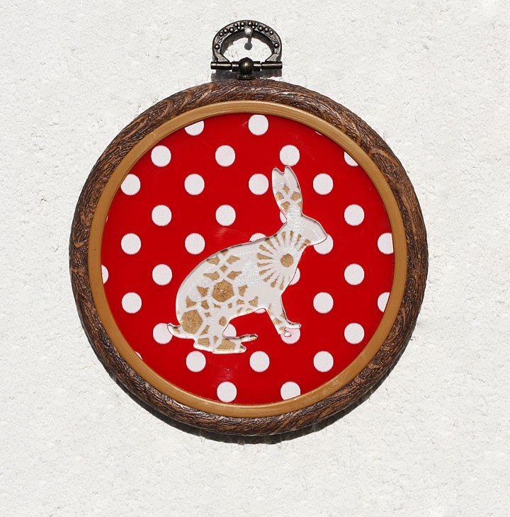 Acrylic doily rabbit hoop wall art hanging on red polka dots